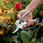 person cutting flower with ratchet pruners